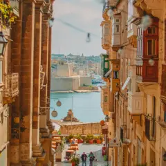 Calle estrecha con balcones de madera y vistas al mar. Ideal para escapadas fin de semana Europa.