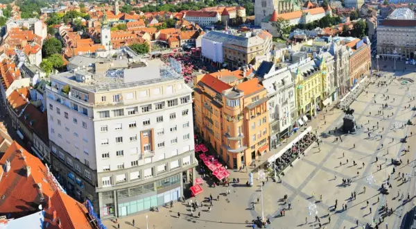 Vista aérea de la plaza principal de Zagreb, con edificios históricos, gente paseando y terrazas. Un lugar ideal para descubrir qué ver en Zagreb.